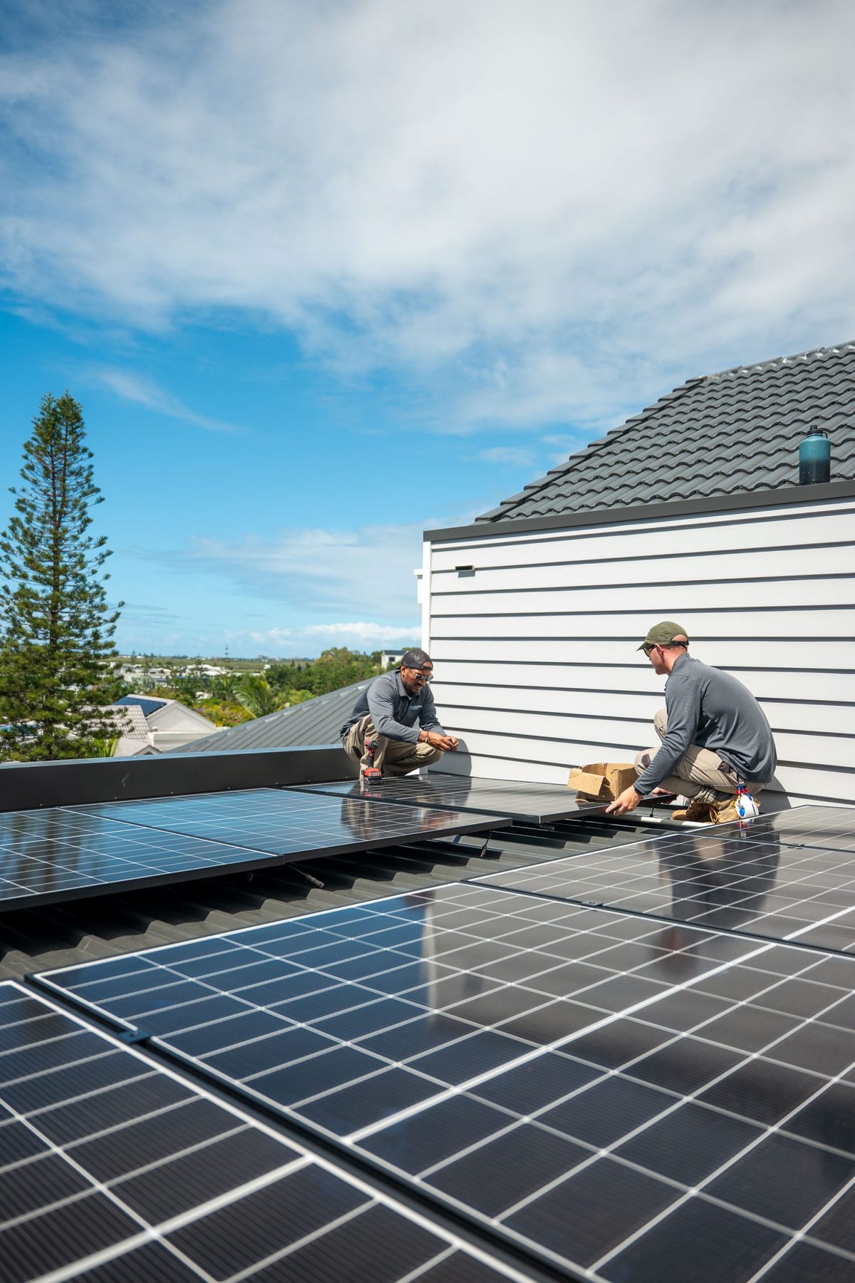 Two members of Luxgrid’s team working on a rooftop solar installation